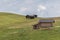 Small wooden farm house, cottage or log cabins on meadow on Alpe di Siusi, Seiser Alm, South Tyrol, Italy