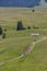 Small wooden farm house, cottage or log cabins on meadow on Alpe di Siusi, Seiser Alm, South Tyrol, Italy