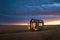 small wooden home on wheels in middle of prairies tiny house in evening