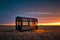 small wooden home on wheels in middle of prairies tiny house in evening