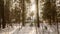 small wooden house in a snow-covered winter forest. slow horizontal movement of the camera. The sun's rays break