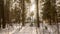 small wooden house in a snow-covered winter forest. slow horizontal movement of the camera. The sun's rays break
