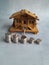 Small wooden house with some coins and a key.