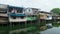 Small wooden houses on canal bank in the city