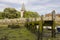 A small wooden jetty covered with barnacles and seaweed in the harbour at Bosham village in West sussex in the South of England