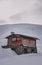 Small wooden Log Cabin in the Snow.