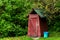 Small wooden outdoors toilet in summer