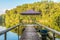 Small wooden pier for pleasure pedal catamaran on the forest lake shore