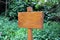 Small wooden plaque against a green background