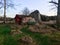 Small wooden red cabin beside the huge stone in Sweden