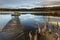 Small woody fishing pier at the lake.