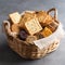 A small, woven cracker basket filled with a variety of crackers