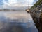 Small yachts and boat in Spiddal pier, county Galway, Ireland. Blue cloudy sky reflects in water. Warm sunny day. Nobody