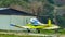 Small yellow airplane near its garage