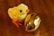 Small Yellow Baby Chick With A Golden Easter Egg On A Wood Table
