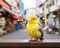 a small yellow bird sitting on a ledge