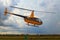 A small yellow helicopter takes off. Storm clouds in the background. A small private airfield in Zhytomyr, Ukraine