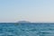 Small yellow motorized boat with one man sails in the open sea