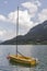 Small yellow sailing yacht on Alpine lake Mondsee in Austria