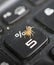 Small yellow spider on a dusty and dirty laptop keyboard