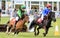 Small young children racing on shetland ponies