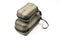 Smaller closed case for remote control lies on top of bigger case for drone body with metallic khaki color on white background