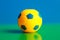 Smalll toy ball on a green and blue background