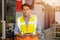 Smart adult professional Asian male engineer worker standing with CNC heavy machine and tablet computer in hand