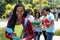 Smart african american female student with group of students