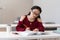 Smart asian girl writing outline while preparing for exam in reading room or classroom