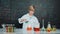 Smart boy inspect mixed liquid in laboratory beakers while holding. Erudition.