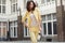 Smart brunette lady clothed yellow suit