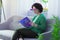 Smart brunette woman sitting with a book