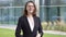 Smart business woman standing over modern building.