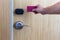 Smart card door key lock system in hotel. Hotel electronic lock on wooden door. Entrance door with electronic card lock security.