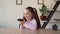 Smart child caucasian teen girl uses a smartphone voice assistant asking him questions on her mobile gadget. Free time