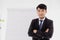 Smart confident Asian adult business man. office employee standing arm crossed looking camera