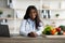 Smart eating and healthy nutrition concept. Portrait of female dietitian smiling at camera, sitting at workplace