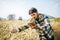 Smart farmer checking barley farm with tablet