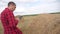 Smart farming agriculture concept. man lifestyle farmer studying a haystack in a field on a digital tablet. slow motion