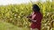 Smart farming concept African man agronomist holds tablet in the corn field