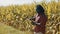 Smart farming concept. African man agronomist holds tablet in the corn field