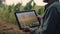 smart farming, futuristic agriculture concept: farmer carrying smart tablet, diagrams, statistics, graphic