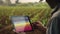 smart farming, futuristic agriculture concept: farmer carrying smart tablet, diagrams, statistics, graphic