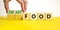 Smart food symbol. Doctor turns cubes and changes words `food` to `smart food`. Beautiful yellow table, white background. Medi