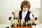 Smart games. A child plays chess. Boy and a chessboard. Strategy. Logical thinking. Competition, tournament. Brain