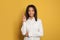 Smart happy african american woman pointing finger up on vivid yellow studio background