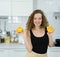 smart healthy woman happy, smile, hold orange in hands before mixing healthy fruit juice in kitchen with copy space. beautiful