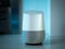 Smart home speaker assistant device in home setting with coloured LED mood lighting - cerulean blue