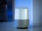 Smart home speaker assistant device in home setting with coloured LED mood lighting - dark blue